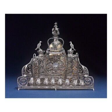 View full screen - View 1 of Lot 176. A POLISH PARCEL-GILT SILVER AND FILIGREE 'BAAL SHEM TOV' HANUKAH LAMP, UNCLEAR ITALIC MAKER'S MARK, CIRCA 1830-40.
