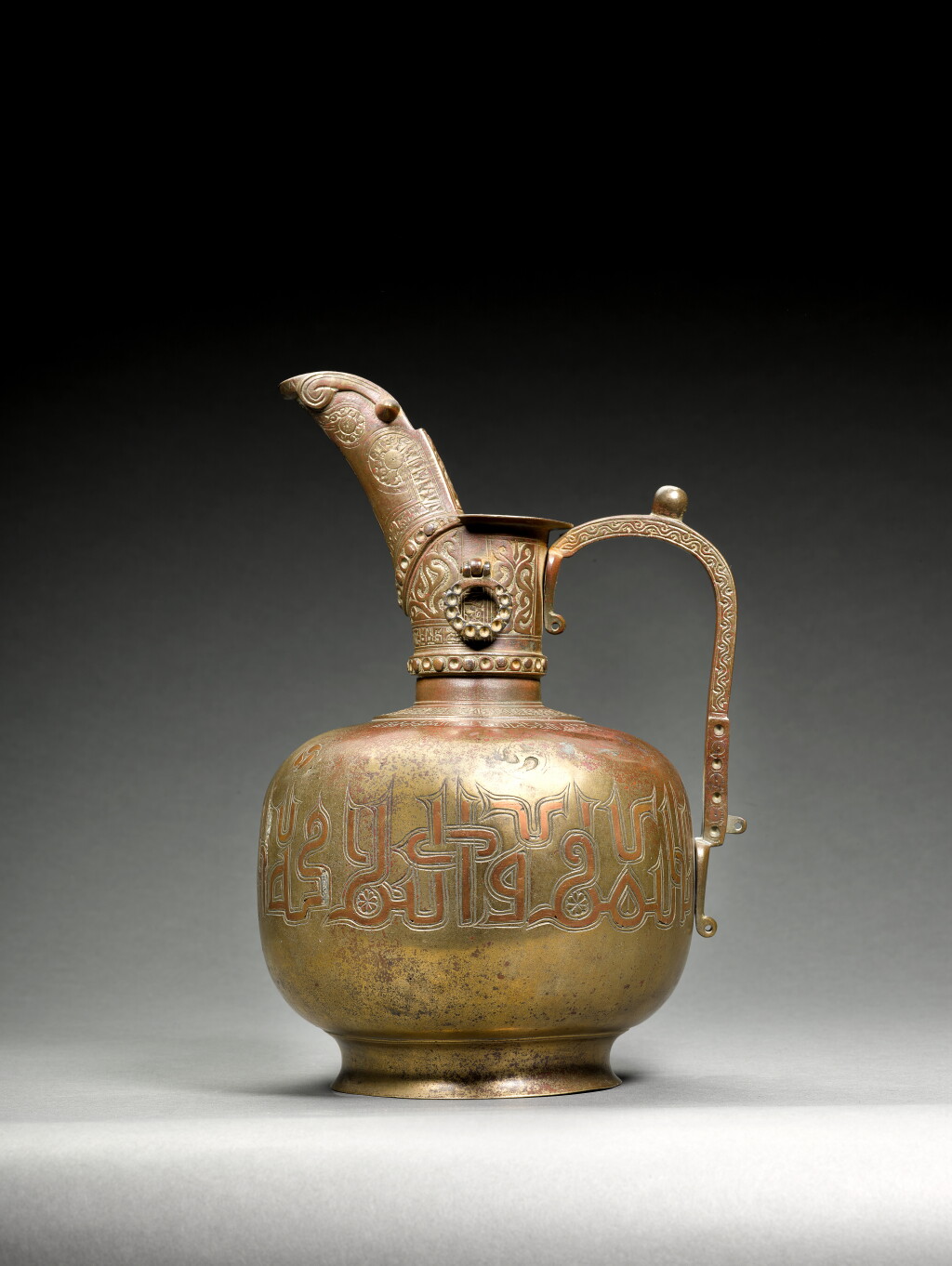View full screen - View 1 of Lot 8. A Khurasan silver and copper-inlaid bronze ewer, North Eastern Persia, late 12th/early 13th century.