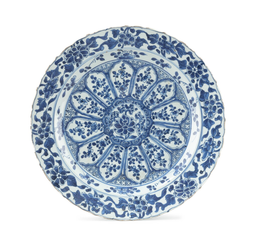 View full screen - View 1 of Lot 379. A foliate 'floral' blue and white charger, China, Qing Dynasty, Kangxi period.