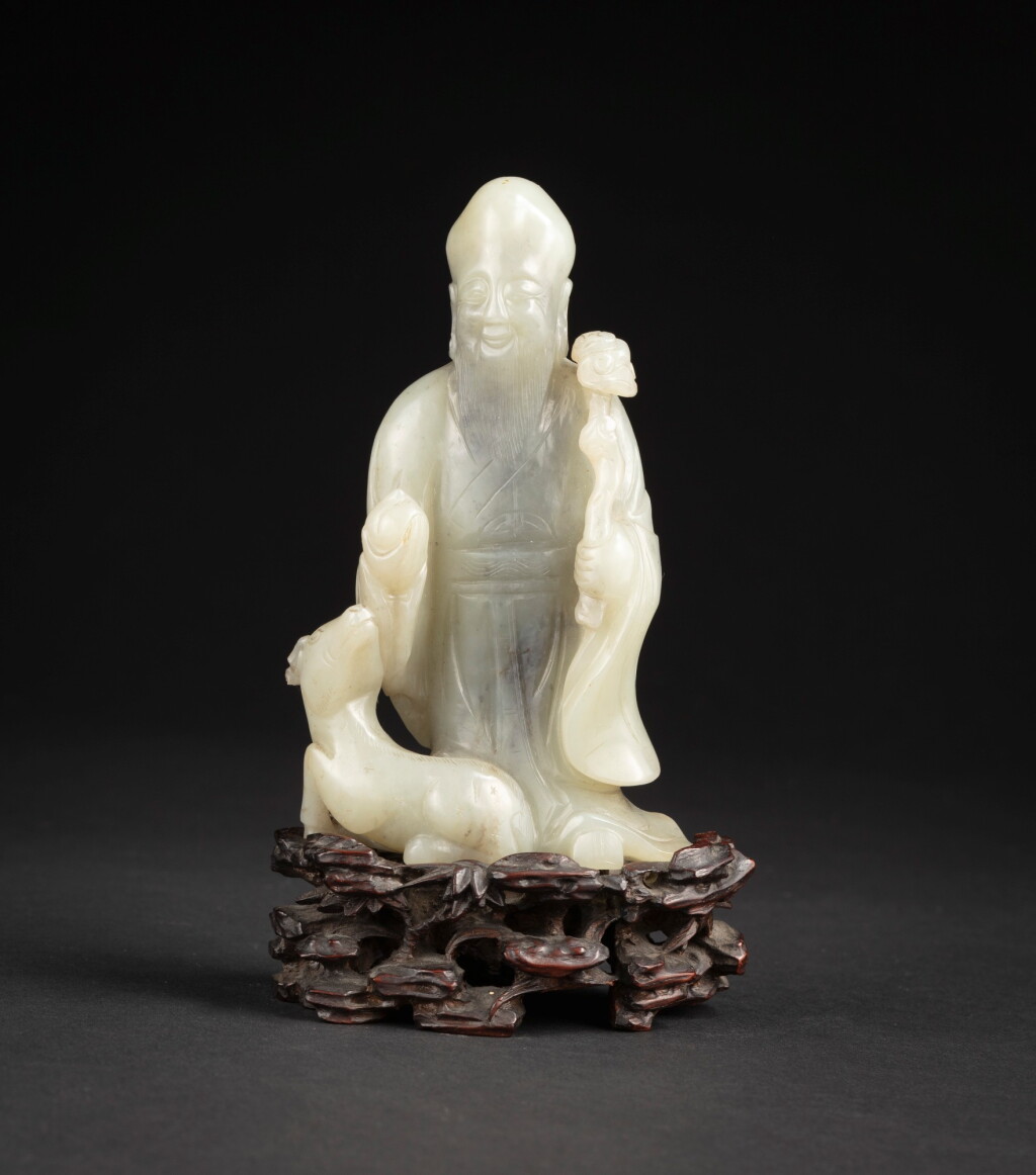 View full screen - View 1 of Lot 110. A celadon jade Shoulao and deer Qing dynasty, 19th century | 清十九世紀 青白玉雕壽老擺件.