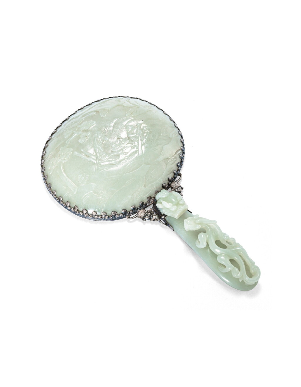 View full screen - View 1 of Lot 149. A pale celadon jade and silver hand mirror, Qing dynasty, 19th century | 清十九世紀 銀嵌青白玉容鏡.
