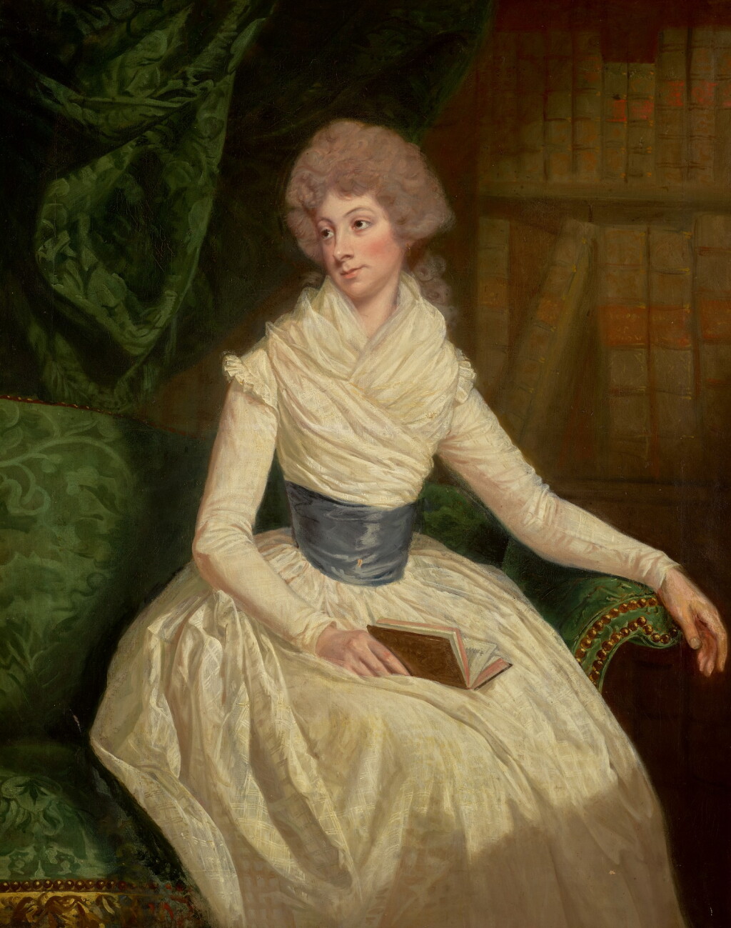 View full screen - View 1 of Lot 87. THOMAS BEACH, R.A. | Portrait of Mrs Maria Anne Penrudokke, three-quarter-length, in a white dress and blue sash, seated in a library, holding a book.