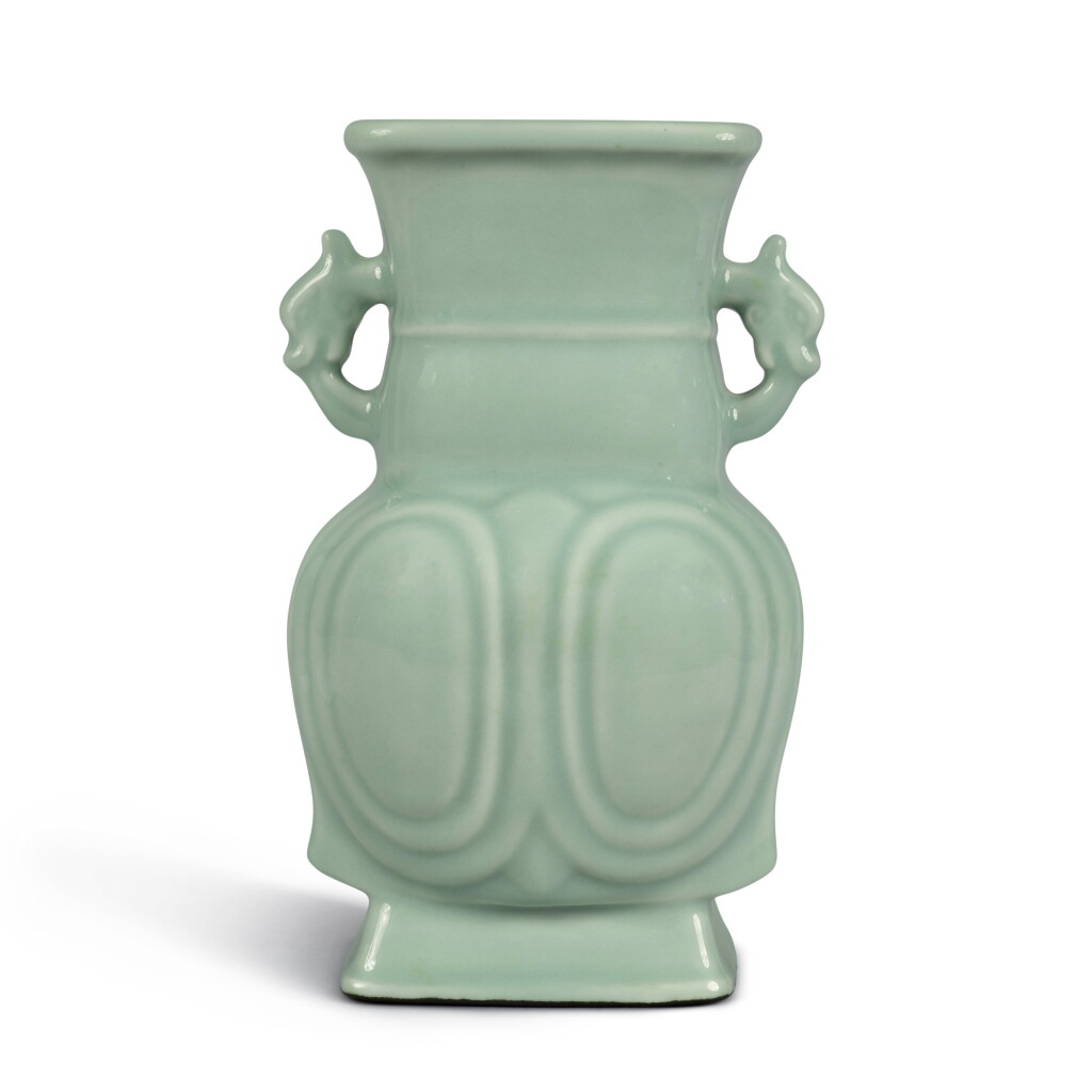 View full screen - View 1 of Lot 649. A molded archaistic celdon-glazed handled vase, Qing dynasty, 18th century | 清十八世紀 粉青釉龍耳壺.