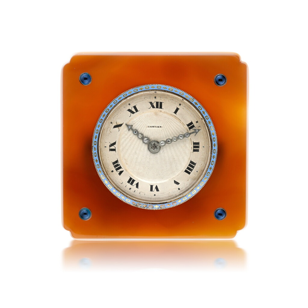 View full screen - View 1 of Lot 108. CARTIER | AN AGATE, GILT METAL, DIAMOND AND SAPPHIRE-SET DESK TIMEPIECE, CIRCA 1925.