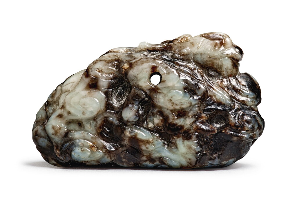 View full screen - View 1 of Lot 688. A brown and celadon jade 'mythical beast' pendant, Qing dynasty.