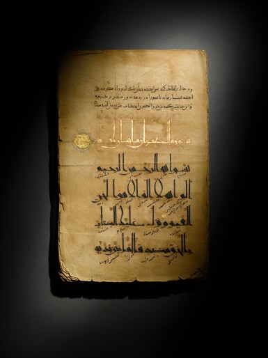 View full screen - View 1 of Lot 9. An illuminated Qur’an section in Eastern Kufic script with commentary, Khurasan or Central Asia, Ghaznavid, late 11th/early 12th century.