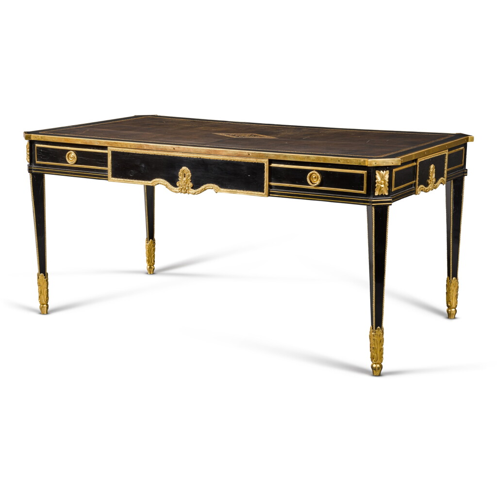 View full screen - View 1 of Lot 6. A Louis XVI style ebony bureau plat, late 19th century, in the manner of Martin Carlin.