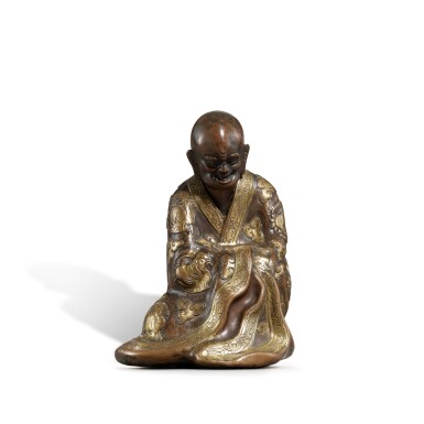 View full screen - View 1 of Lot 812. A parcel-gilt bronze figure of a luohan, Late Ming - early Qing dynasty | 明末至清初 銅局部鎏金羅漢坐像.