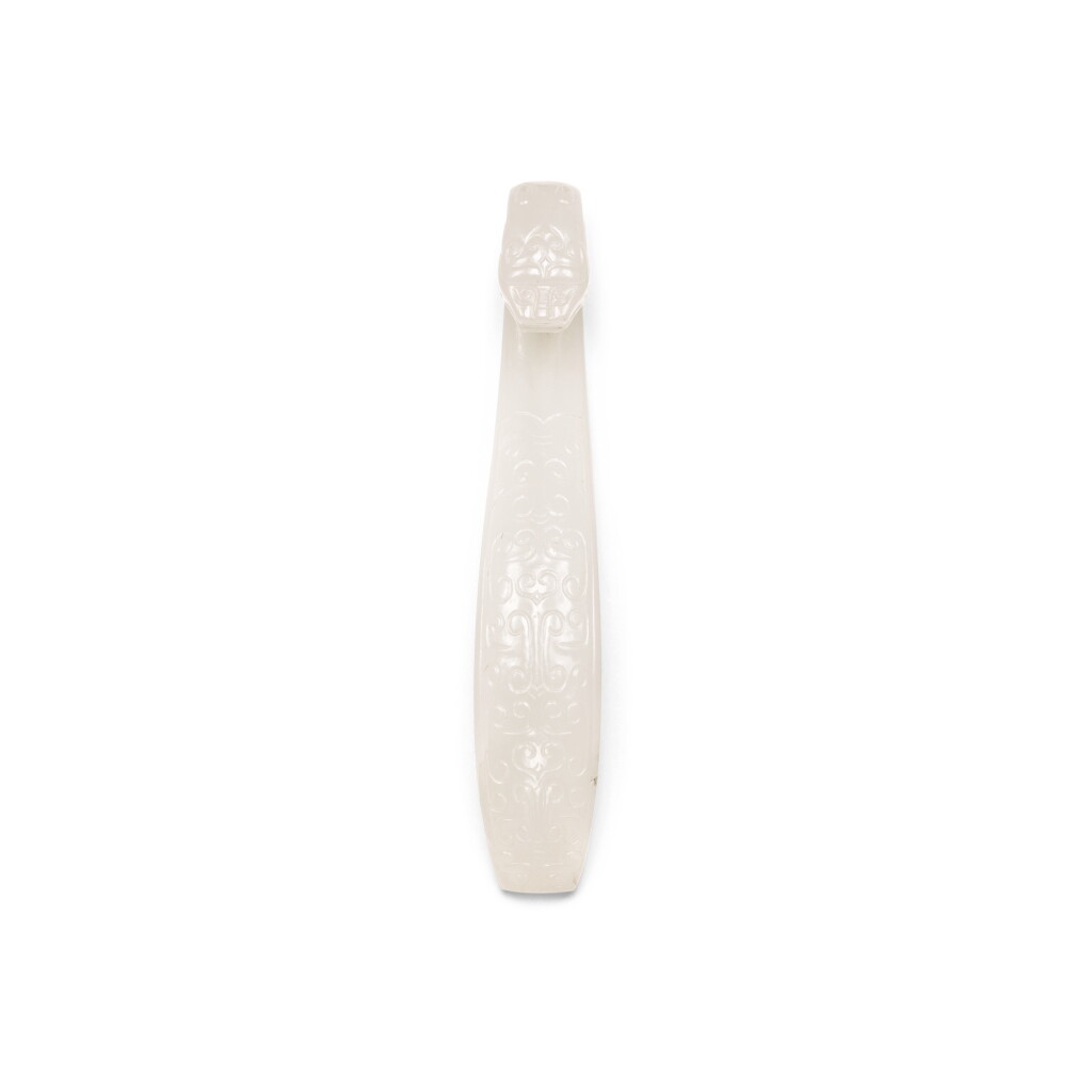 View full screen - View 1 of Lot 240. A WHITE JADE BELT HOOK, QING DYNASTY, 18TH CENTURY | 清十八世紀 白玉仿古龍紋帶鉤.