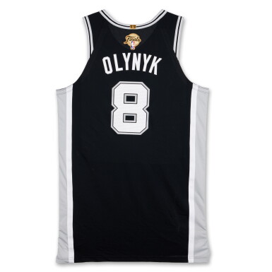 View full screen - View 1 of Lot 18. Kelly Olynyk San Antonio Spurs 2026 NBA Finals Game Issued Icon Edition Jersey | Game 3 | Matched to Game 3 Locker Room Image .