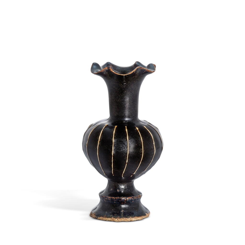 View full screen - View 1 of Lot 354. A Cizhou black-glazed ribbed floriform lobed vase, Song dynasty 宋 磁州窰黑釉堆線紋百合口瓶.