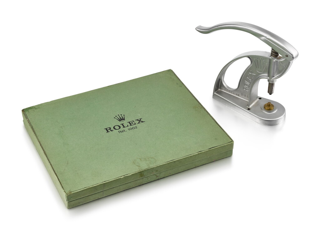 View full screen - View 1 of Lot 8107. ROLEX | REFERENCE 1002, A STAINLESS STEEL STAKING TOOL FOR BEZELS AND CRYSTALS, CIRCA 1965 AND 23 BRASS JIGS AND ORIGINAL FITTED BOX, CIRCA 1981.
