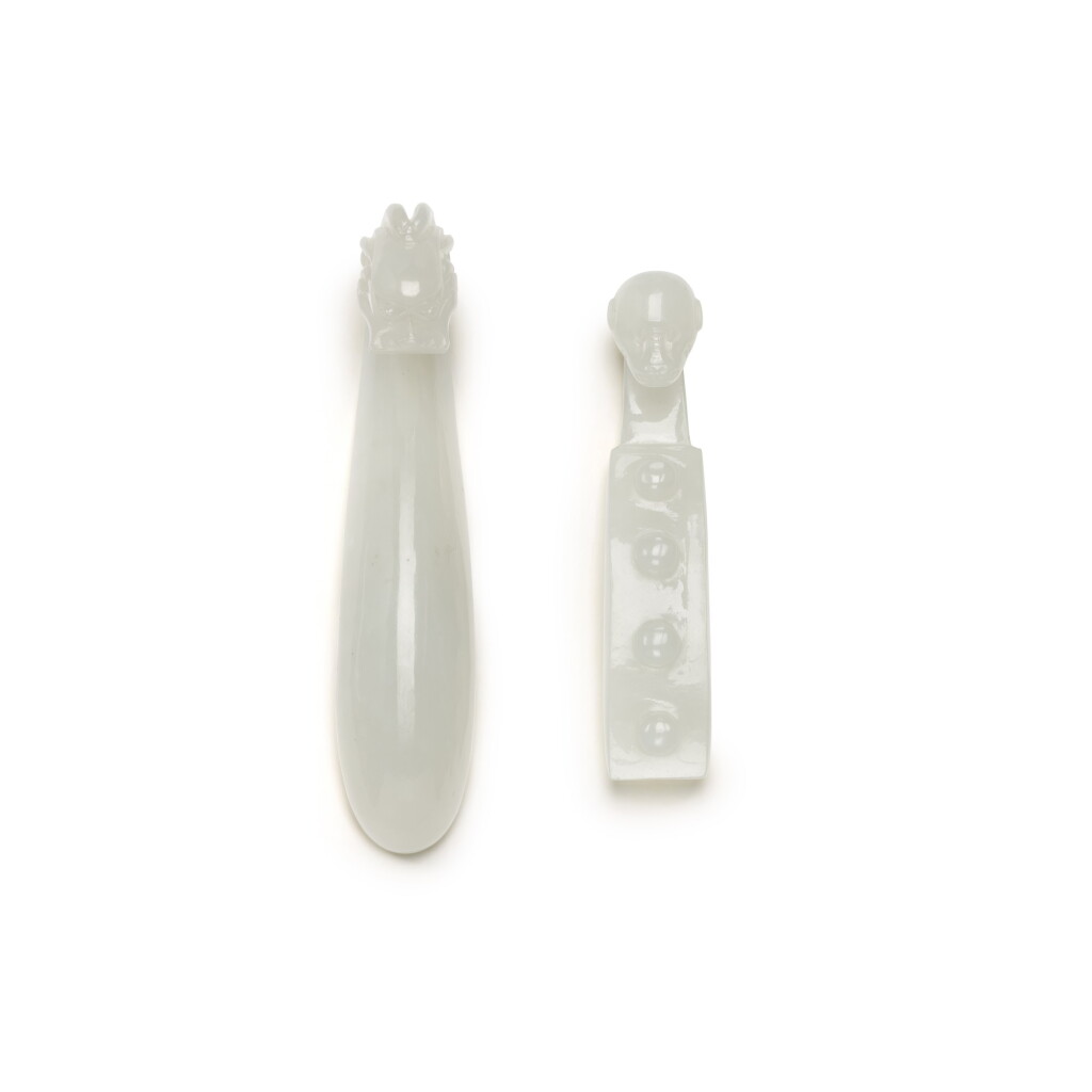View full screen - View 1 of Lot 221. TWO PALE CELADON JADE BELT HOOKS, QING DYNASTY, 19TH CENTURY | 清十九世紀 青白玉雕螭龍紋帶鉤 及 白玉猴首帶鉤 一組兩件.