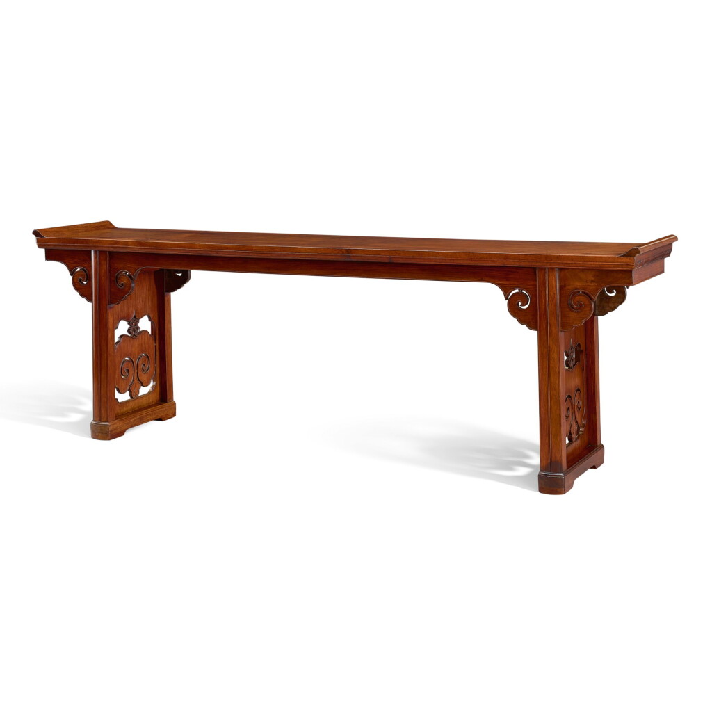 View full screen - View 1 of Lot 5. A HUANGHUALI RECESSED-LEG LONG TABLE, QIAOTOUAN MING DYNASTY, 17TH CENTURY | 明十七世紀 黃花梨如意雲牙頭夾頭榫帶托子翹頭案.