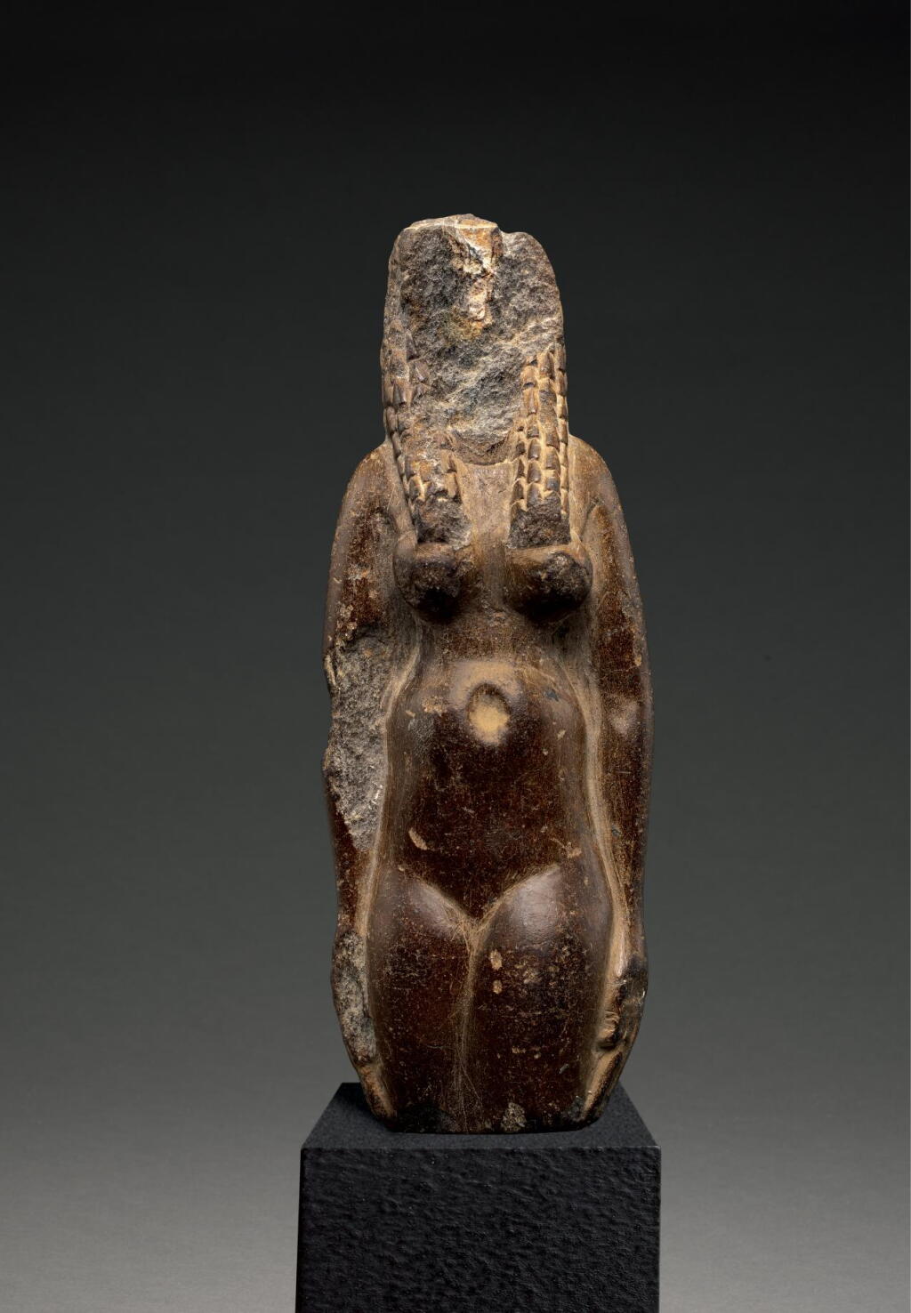 View full screen - View 1 of Lot 269. AN EGYPTIAN FRAGMENTARY BROWN STEATITE FIGURE OF HATHOR, PTOLEMAIC PERIOD, CIRCA 305-30 B.C..