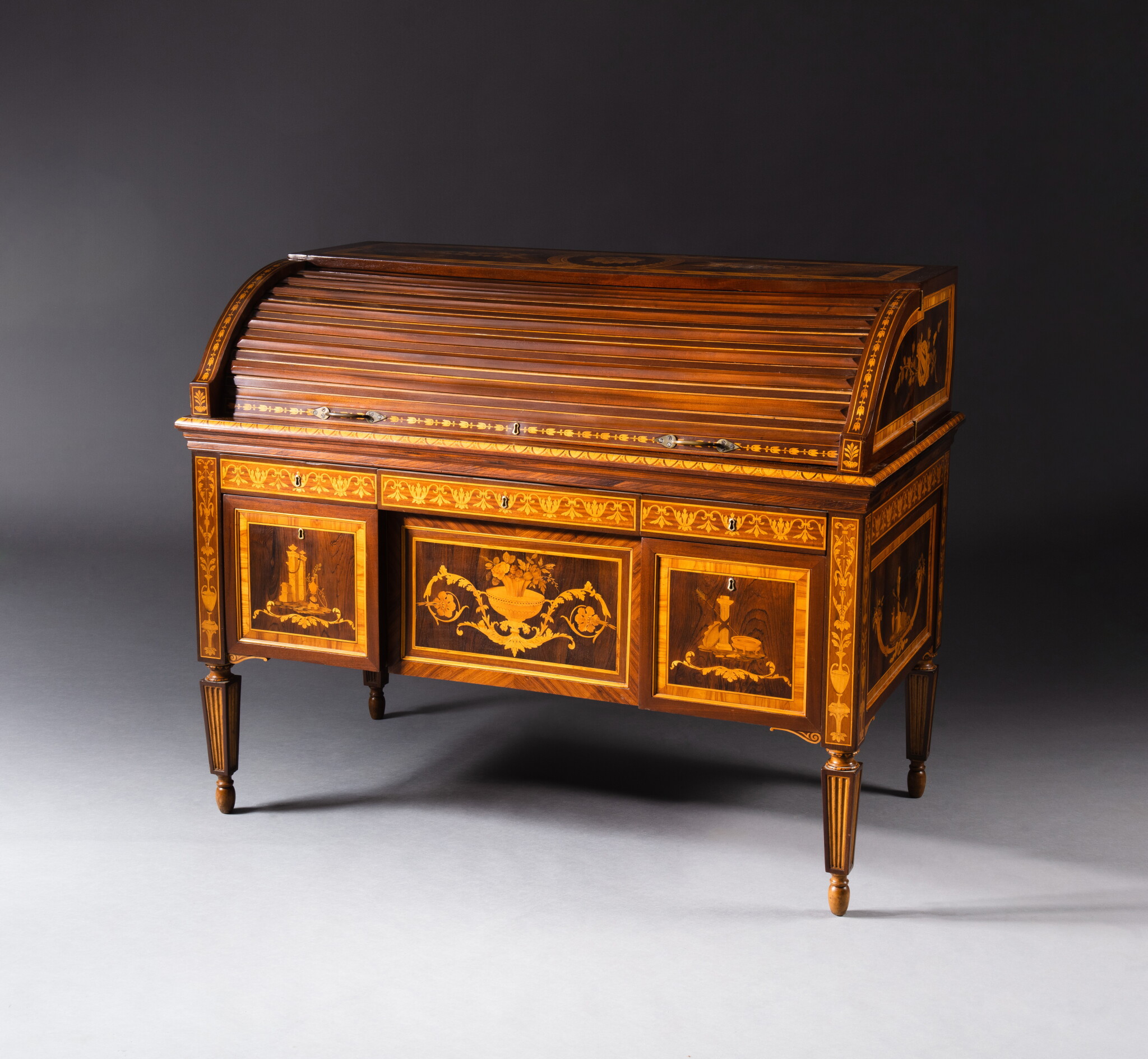 A rosewood, tulipwood, amaranth and mahogany marquetry sliding desk,