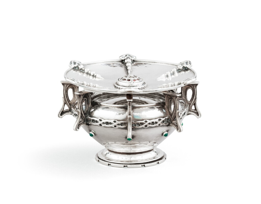 View full screen - View 1 of Lot 17. An English silver candlestick with emerald cabochons and an English silver saucer with red enamel, both Omar Ramsden, London, the candlestick 1927, the saucer 1938.