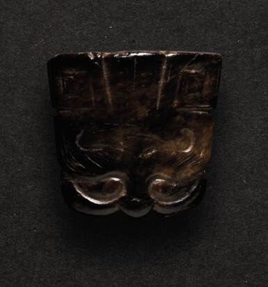 View full screen - View 1 of Lot 229. A SMALL BLACK JADE CARVING OF A TAOTIE MASK PENDANT SHANG DYNASTY OR LATER | 商或以後 玉饕餮紋珮.