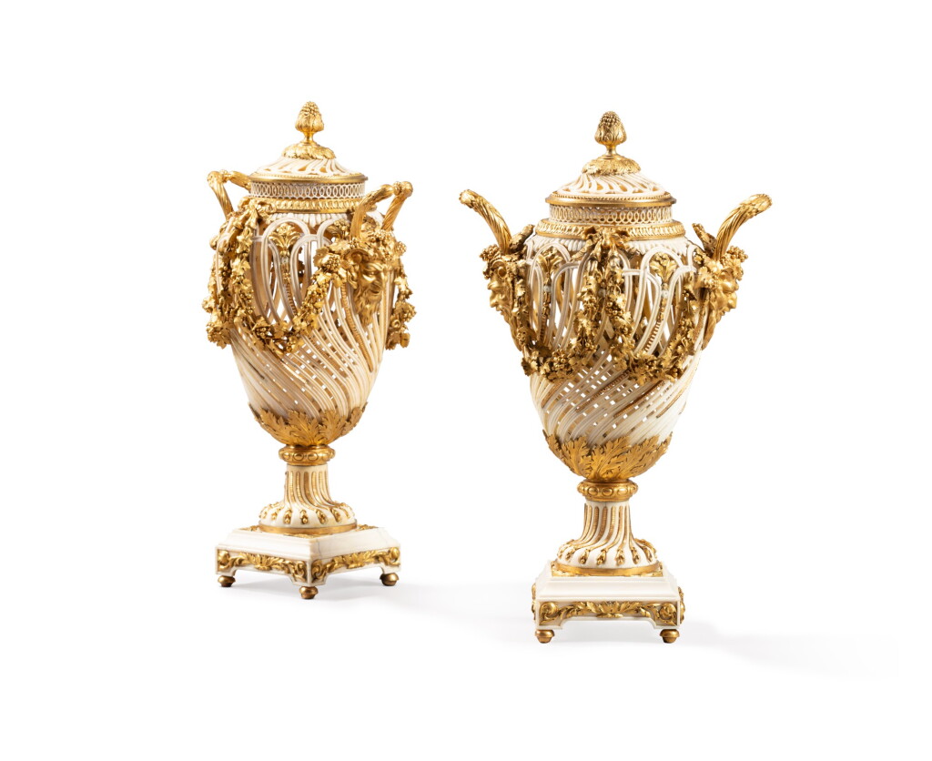 View full screen - View 1 of Lot 73. A pair of Louis XVI gilt-bronze mounted turned and engraved ivory covered vases by Francois Voisin and Pierre-Philippe Thomire, circa 1785.