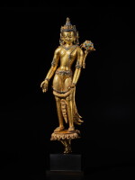 A large silver and semi-precious stone-inlaid gilt-copper alloy figure of Padmapani, Tibet, 14th / 15th century