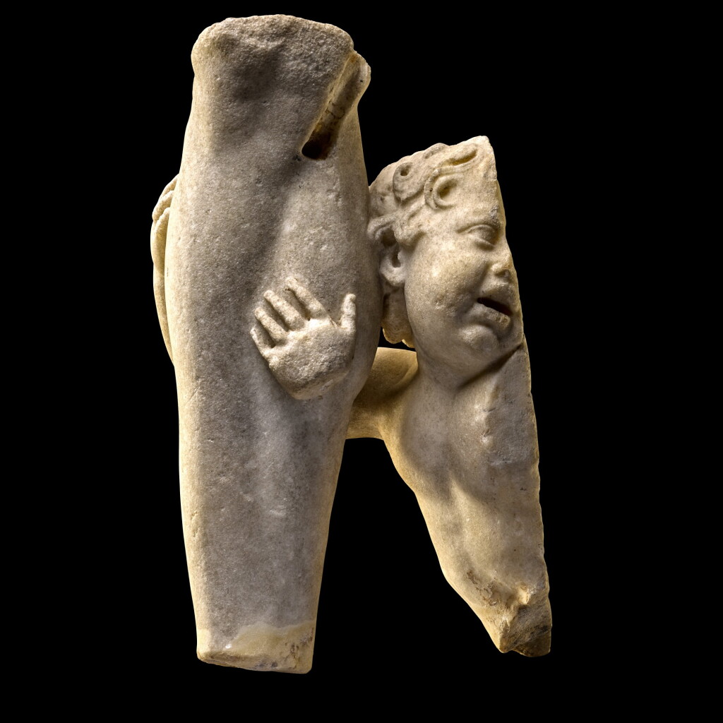 View full screen - View 1 of Lot 38. A ROMAN FRAGMENTARY MARBLE GROUP OF EROS EMBRACING THE LEG OF A GOD, CIRCA 2ND CENTURY A.D..
