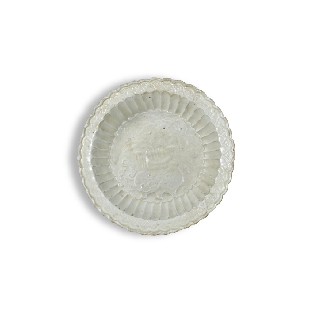 View full screen - View 1 of Lot 84. A rare moulded 'Ding' 'flower vessel' dish, Jin dynasty.