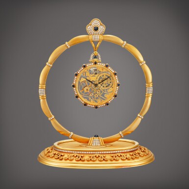 View full screen - View 1 of Lot 2213. Reference 916 An important yellow gold, diamond and sapphire-set skeletonised open face keyless dress watch with matching stand, Made in 1980 | 百達翡麗 | 型號916 重要黃金鑲鑽石及藍寶石鏤空懷錶,備展示座,1980製.