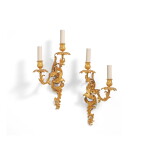 A pair of Louis XV gilt-bronze two-light wall lights, circa 1750, in the style of Jacques Caffiéri
