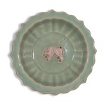 An exceedingly rare biscuit-reserved barbed-rim 'Longquan' celadon-glazed 'bear' dish, Yuan dynasty, Yanyou reign, corresponding to 1314-1320