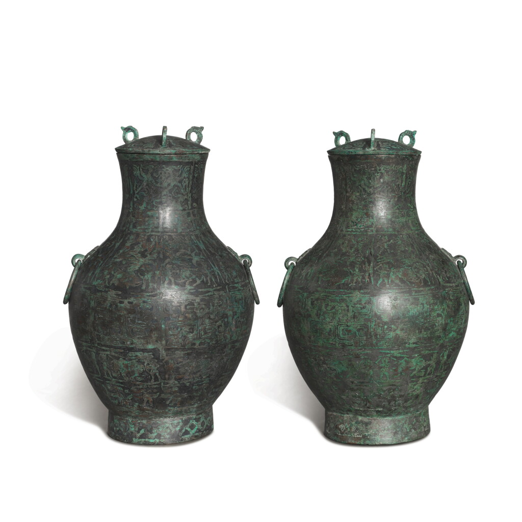 View full screen - View 1 of Lot 1020. A pair of turquoise-paste painted 'hunting' wine vessels and covers, hu, Eastern Zhou dynasty, Warring States period | 東周戰國 青銅松石繪狩獵圖壺一對.