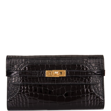 View full screen - View 1 of Lot 49. Hermès Kelly Long Ghillies Wallet of Black Shiny Mississippiensis Alligator with Gold Hardware.