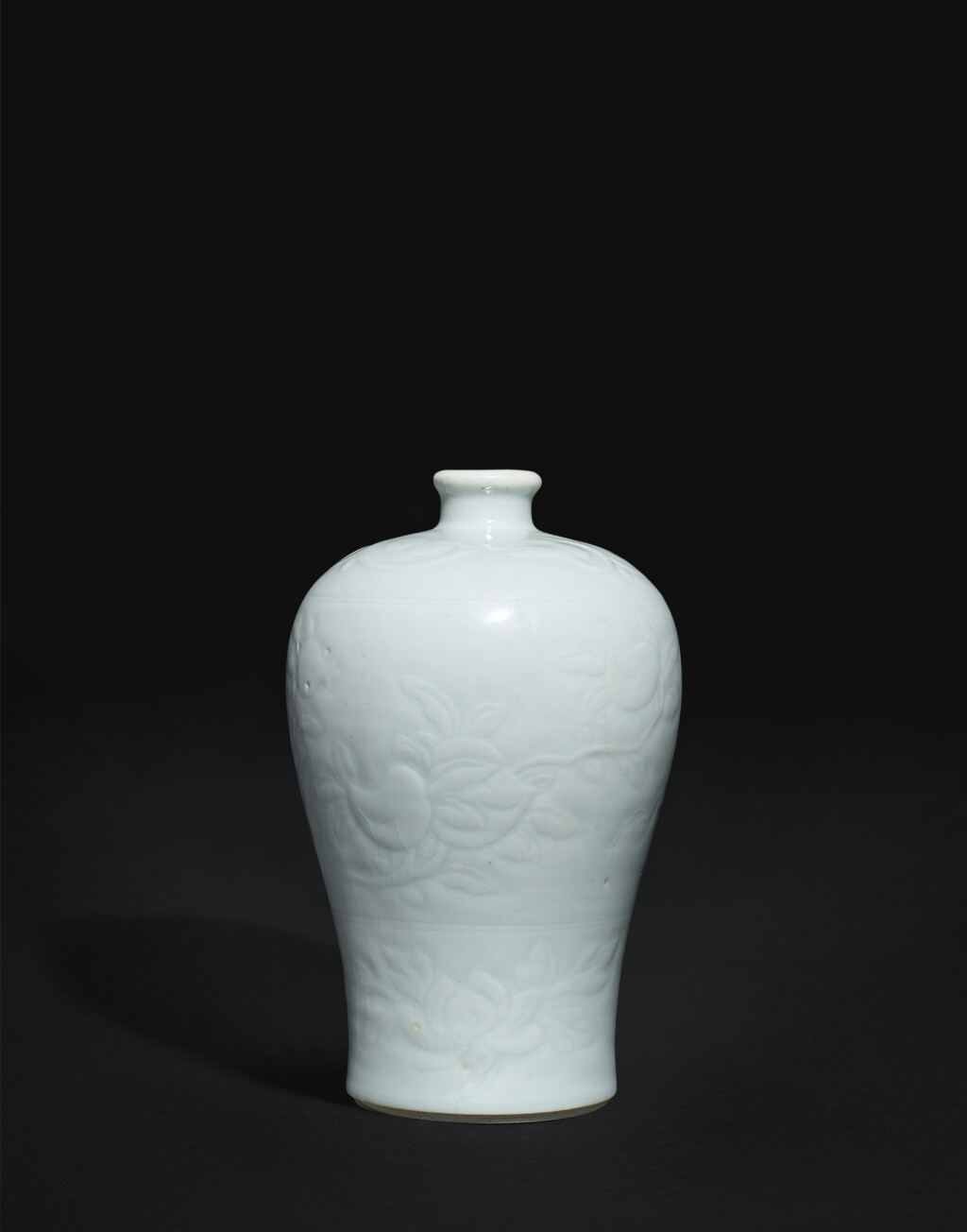 View full screen - View 1 of Lot 3826. A small white-glazed carved 'sanduo' vase, meiping, Qing dynasty, Yongzheng period | 清雍正 白釉劃花三多梅瓶.