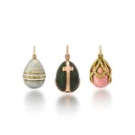 A group of three gold egg pendants in the style of Fabergé