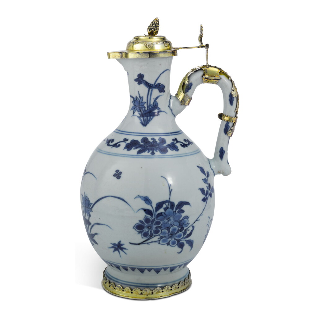 View full screen - View 1 of Lot 27. A CHINESE BLUE AND WHITE PORCELAIN EWER WITH SILVER-GILT MOUNTS, THE PORCELAIN CIRCA 1640; THE MOUNTS MAKER'S MARK HV PROBABLY FOR HEINRICH UDESHEIM, BONN, CIRCA 1735.