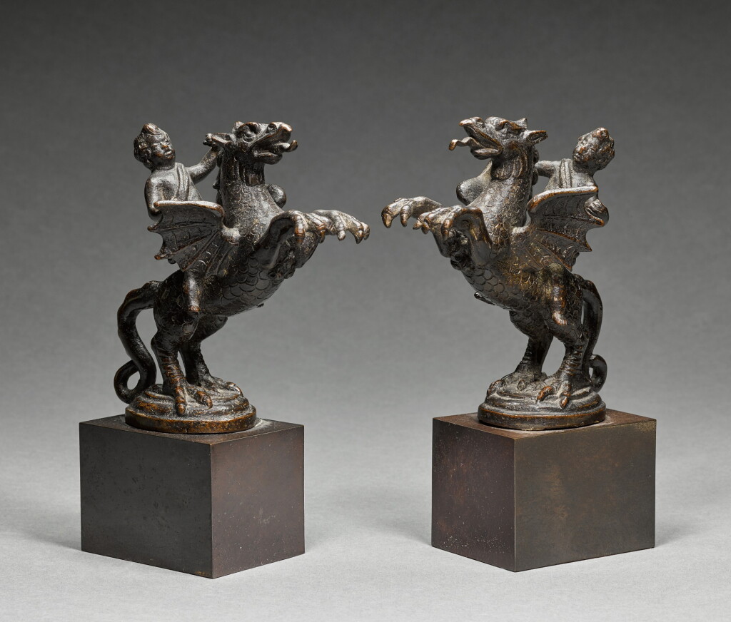 View full screen - View 1 of Lot 220. Pair of finials in the form of putti astride rearing griffins.