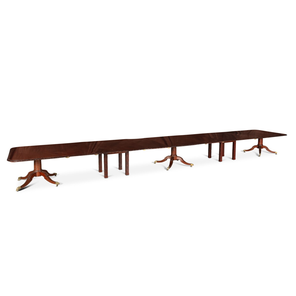 View full screen - View 1 of Lot 89. A Georgian style mahogany three-pillar extending dining table, circa 1950 | Table extensible à trois piètements en acajou de style George III, vers 1950.