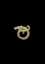 A rare yellowish-celadon jade 'dragon' pendant, Late Warring States period | 戰國晚期 青黃玉卷龍扭絲紋珮