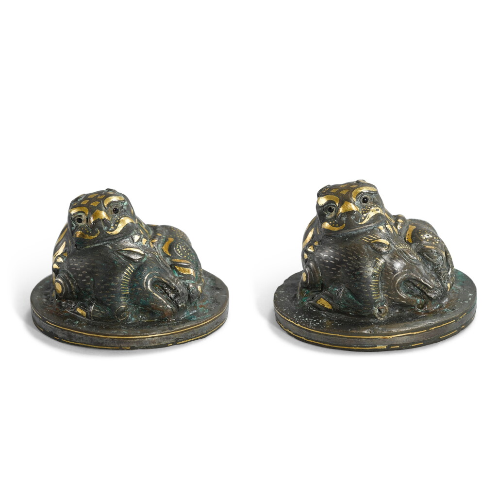 View full screen - View 1 of Lot 1033. A pair of gold and silver-inlaid 'tiger and boar' mat weights, Han dynasty | 漢 銅錯金銀虎噬豚席鎮一對.