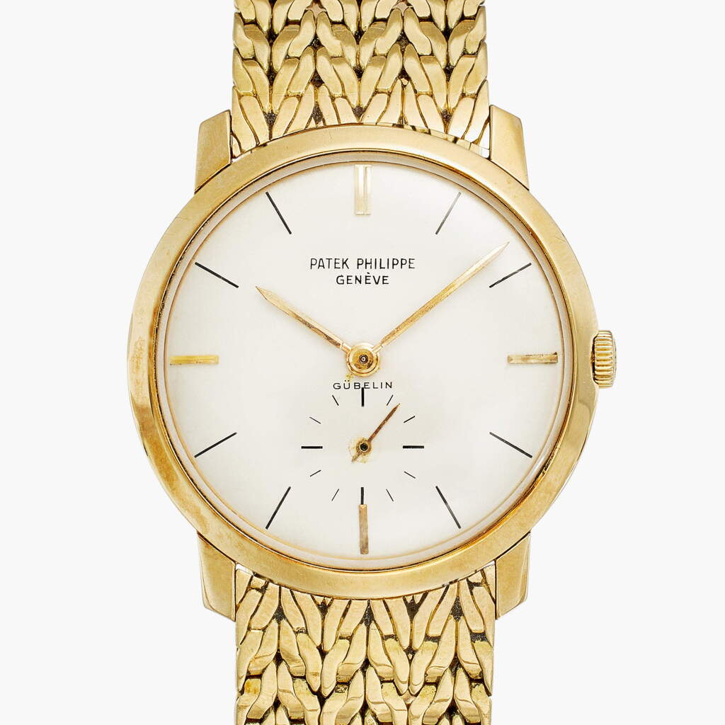 View full screen - View 1 of Lot 26. Reference 2596 Calatrava | Retailed by Gübelin: A yellow gold wristwatch with bracelet, Circa 1960.