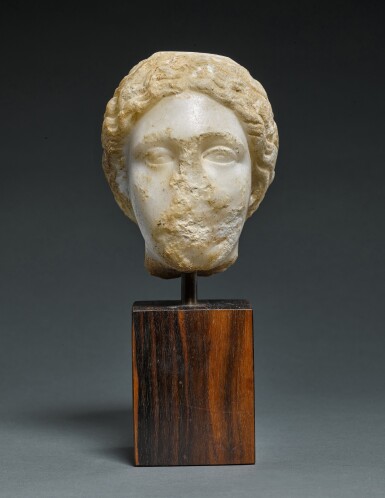 View full screen - View 1 of Lot 12. A Fragmentary Marble Head of a Goddess, circa 2nd Century A.D..