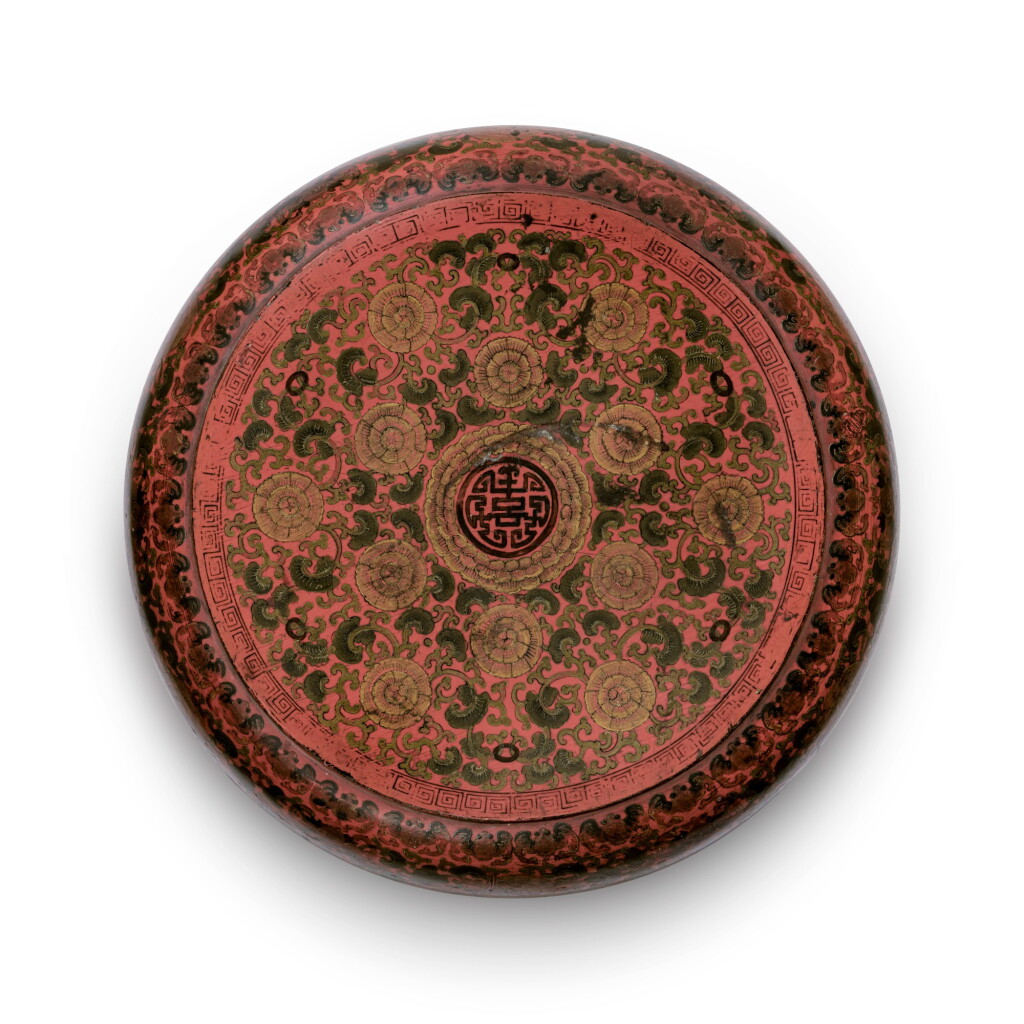 View full screen - View 1 of Lot 86. A painted red lacquer box and cover Qing dynasty, Kangxi period | 清康熙 朱漆彩繪花卉紋「壽」字圓蓋盒.