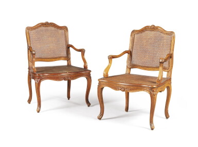 View full screen - View 1 of Lot 12. A pair of Louis XV carved walnut and beechwood caned fauteuils, by Nicolas-Quinibert Foliot, circa 1740 | Paire de fauteuils en noyer sculpté d’époque Louis XV, estampillés N.Q.FOLIOT, vers 1740.