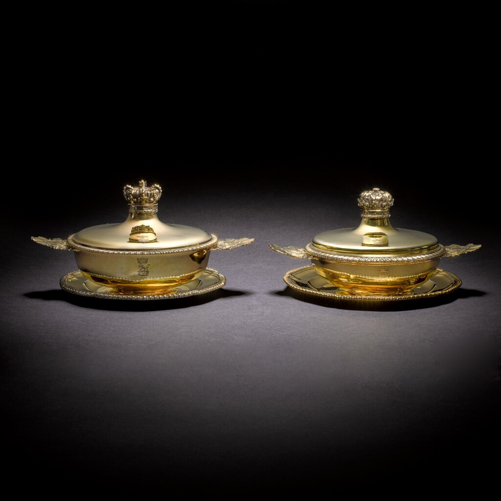 View full screen - View 1 of Lot 33. Royal: a matched pair of George III ecuelles and stands, one Thomas Heming, London, 1764, the other Thomas Hemming, 1770 and 1779.