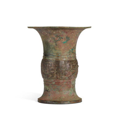 View full screen - View 1 of Lot 399. An archaic bronze ritual wine vessel (Zun), Shang dynasty | 商 青銅饕餮紋尊.
