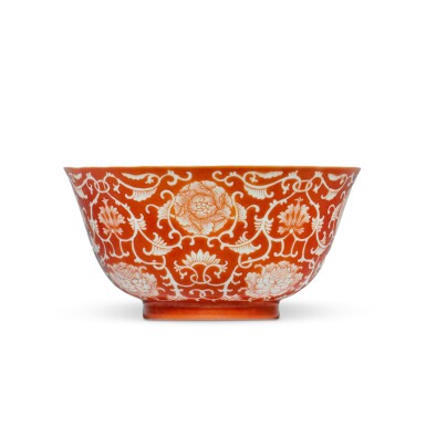 View full screen - View 1 of Lot 385. A coral-ground reverse-decorated 'lotus' bowl, Seal mark and period of Daoguang | 清道光 珊瑚紅地留白纏枝蓮紋盌 《大清道光年製》款.