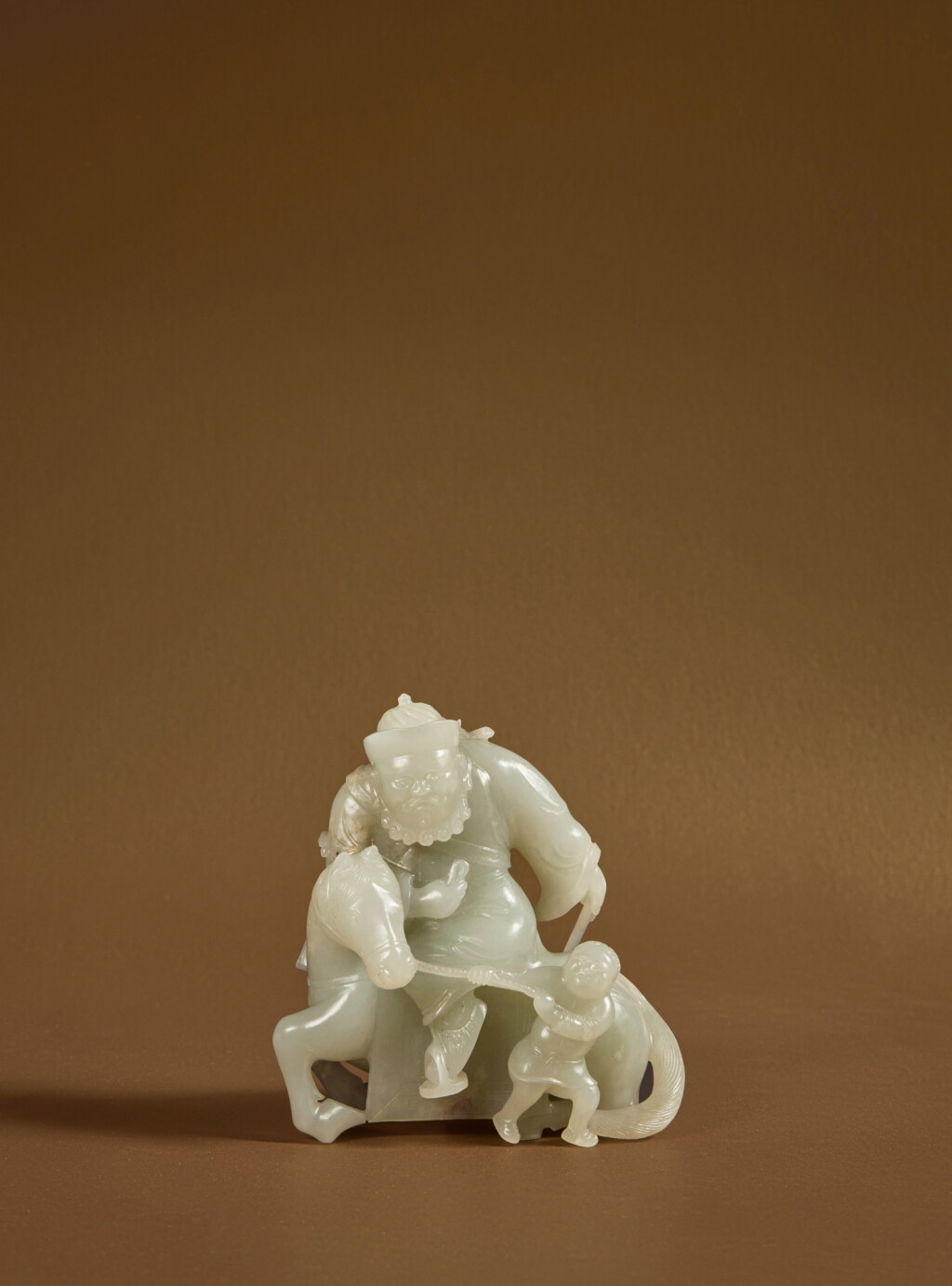 View full screen - View 1 of Lot 94. A pale green jade 'foreigner and groom' group, Early Qing dynasty.