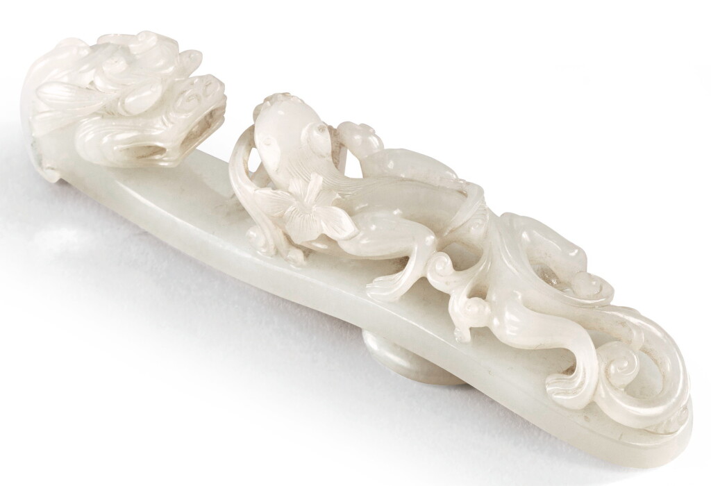 View full screen - View 1 of Lot 63. GRANDE FIBULE EN JADE BLANC DYNASTIE QING, XVIIIE SIÈCLE | 清十八世紀 青白玉透雕螭龍紋帶鉤 | A large white jade belt hook, Qing Dynasty, 18th century.