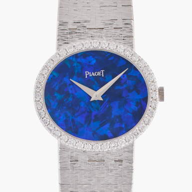 View full screen - View 1 of Lot 530. A white gold and diamond-set bracelet watch with opal dial, Circa 1970.