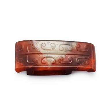 View full screen - View 1 of Lot 546. An agate 'beast mask' scabbard slide Western Han dynasty | 西漢 瑪瑙獸面紋劍璏.