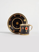 A Sèvres Porcelain 'Jeweled' Black-Ground 'Dauphin' Cup and Saucer (Gobelet litron et soucoupe), circa 1781
